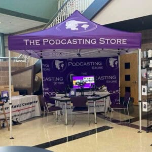 Photo of the purple pop-up display tent for The Podcasting Store set up indoors